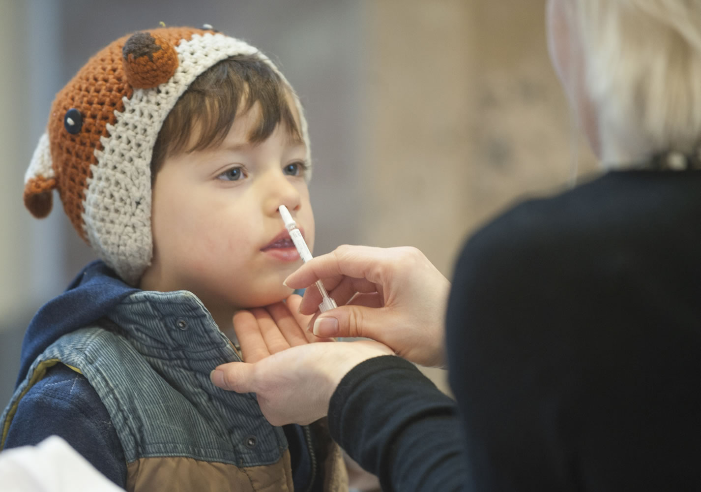 Felix North, 3, gets a flu-mist immunization during a free flu vaccine clinic in 2015 at Legacy Salmon Creek Medical Center in Vancouver. Felix and his mom, Ewa North, were immunized to protect younger brother, 4-month-old Emmett, who is too young to be immunized.