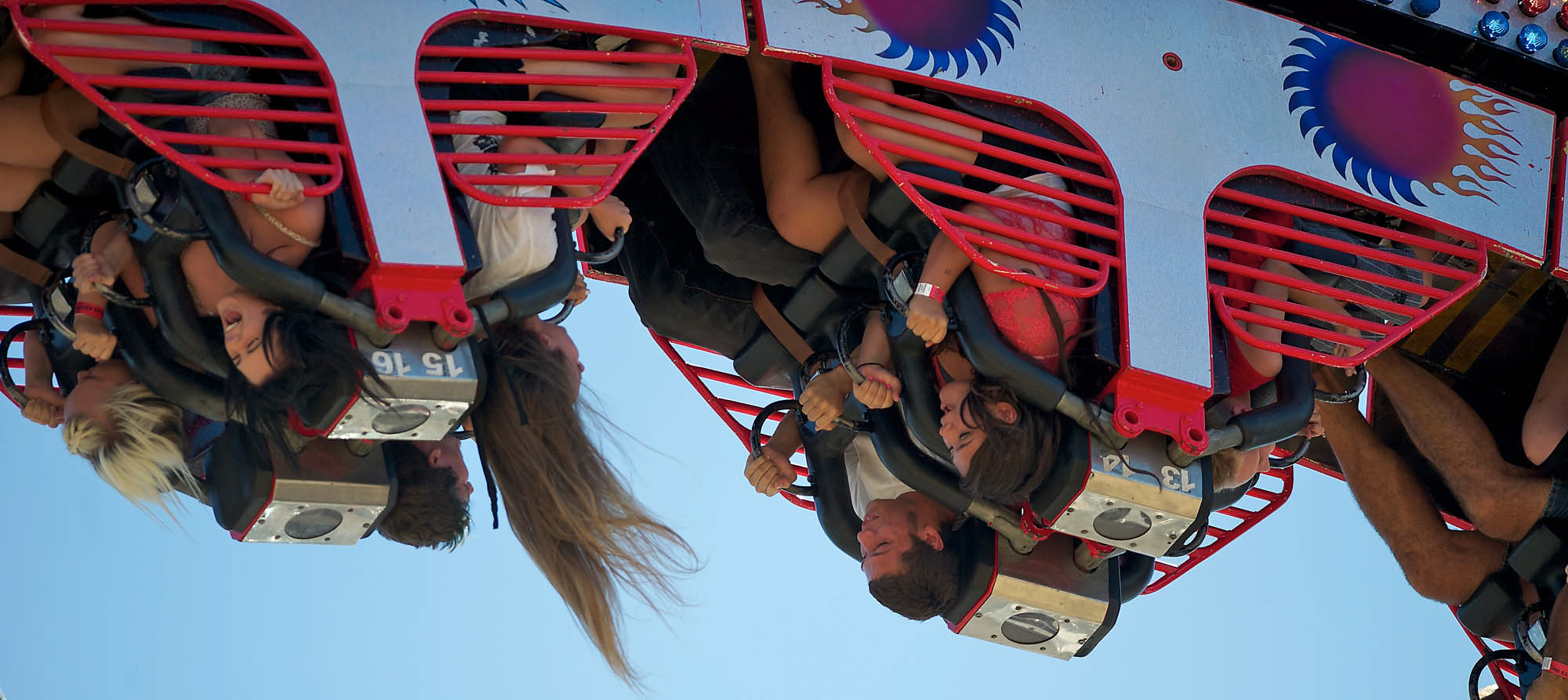 Vancouver residents (from left) Maggie Gorans, 16, and Payton Folk, 16, are whipped upside down Saturday by the &quot;Ring of Fire&quot; carnival ride at the Clark County Fair.