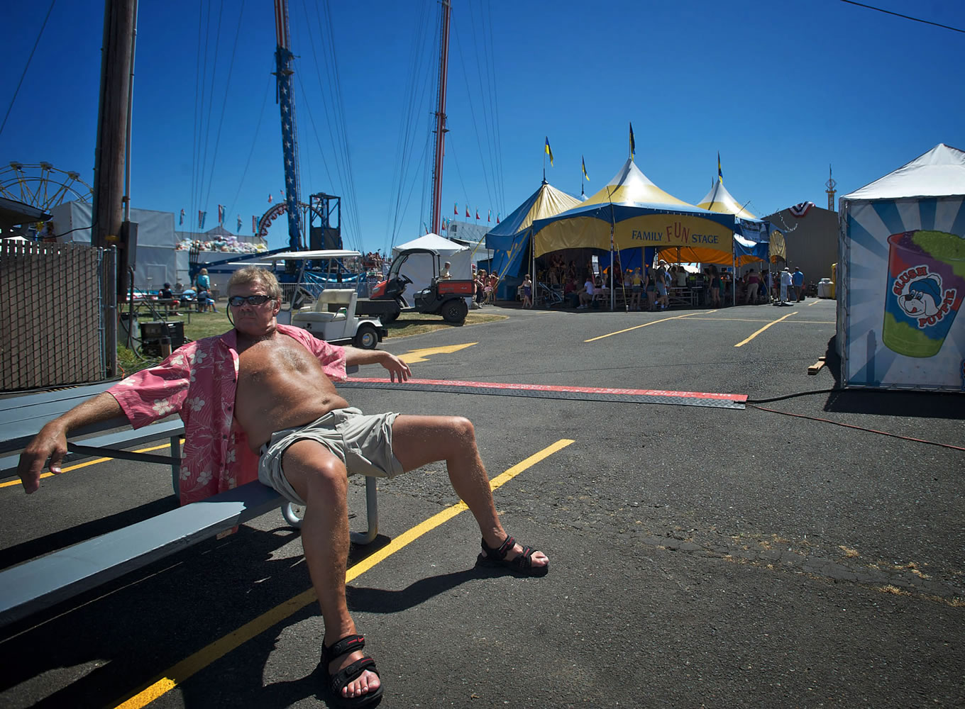 Vancouver native Dennis Kostman, 64, soaks up the sun at the Clark County Fair on Saturday. Kostman says he enjoys the heat.