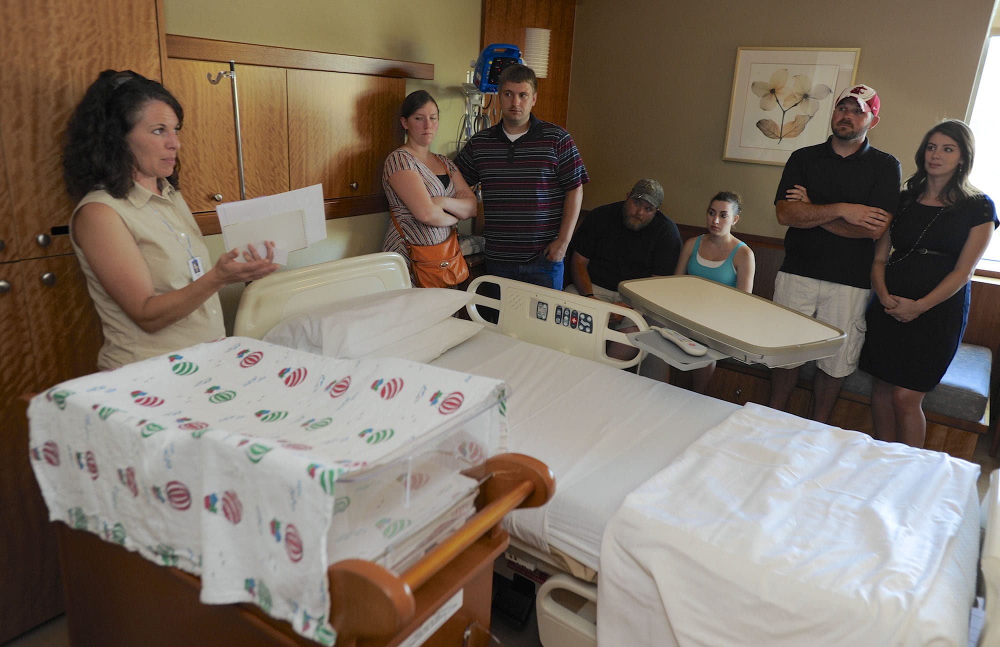Raquel DeWitt with Kaiser Permanente, left, leads a tour through Legacy Salmon Creek Medical Center's Family Birth Center for a group of expectant parents, including from second left, Cherise and Corey Marshall, Mike and Zaneta Kaplan and Troy and Kaylyn Smith. Beginning Oct.