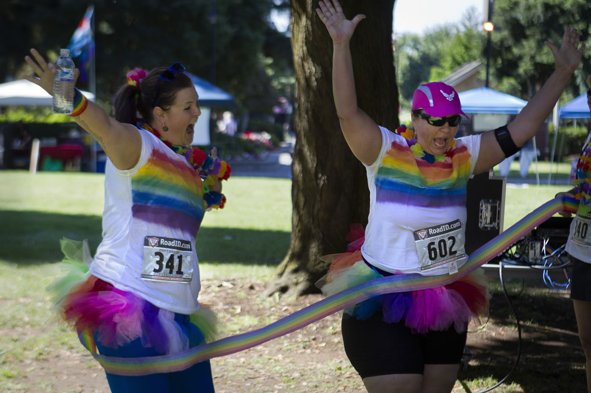 &quot;Rainbow Team&quot; members Sarah Beck and Amy Powell cross the finish line at Lyle's Myles on Saturday.