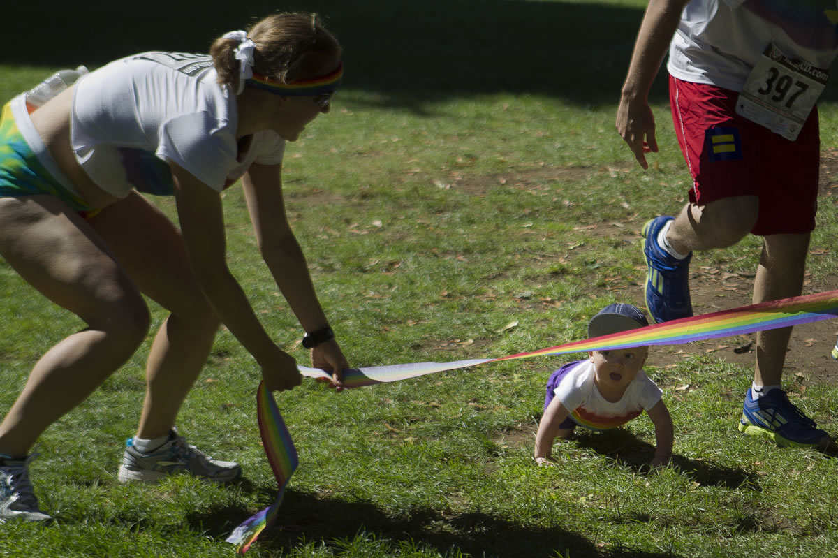 Amy Campbell holds the finish line low for 9-month-old Nolan O'Neill, the youngest &quot;competitor&quot; in the Lyle's Myles Run/Walk Saturday at Esther Short Park.