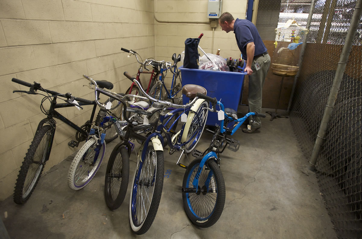 C-Tran spokesman Scott Patterson looks over found items at the agency's headquarters off of Fourth Plain Boulevard. In the summer, about six bikes a month are left on the front of buses by passengers.