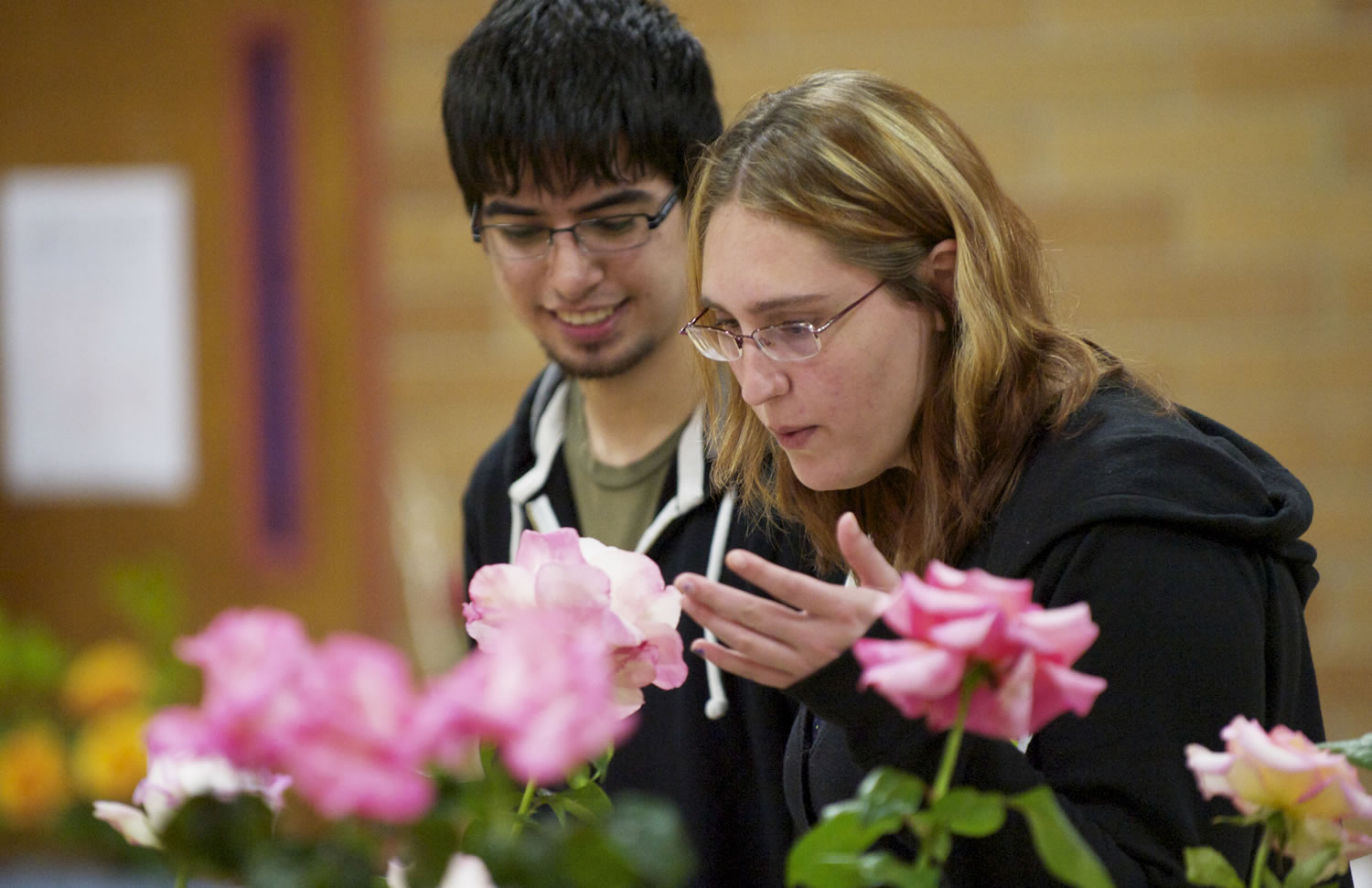 Geoffrey Fuerte-Stone, left, and Sarah Randall, both from Vancouver, enjoy the Fort Vancouver Rose Society rose show on Saturday.