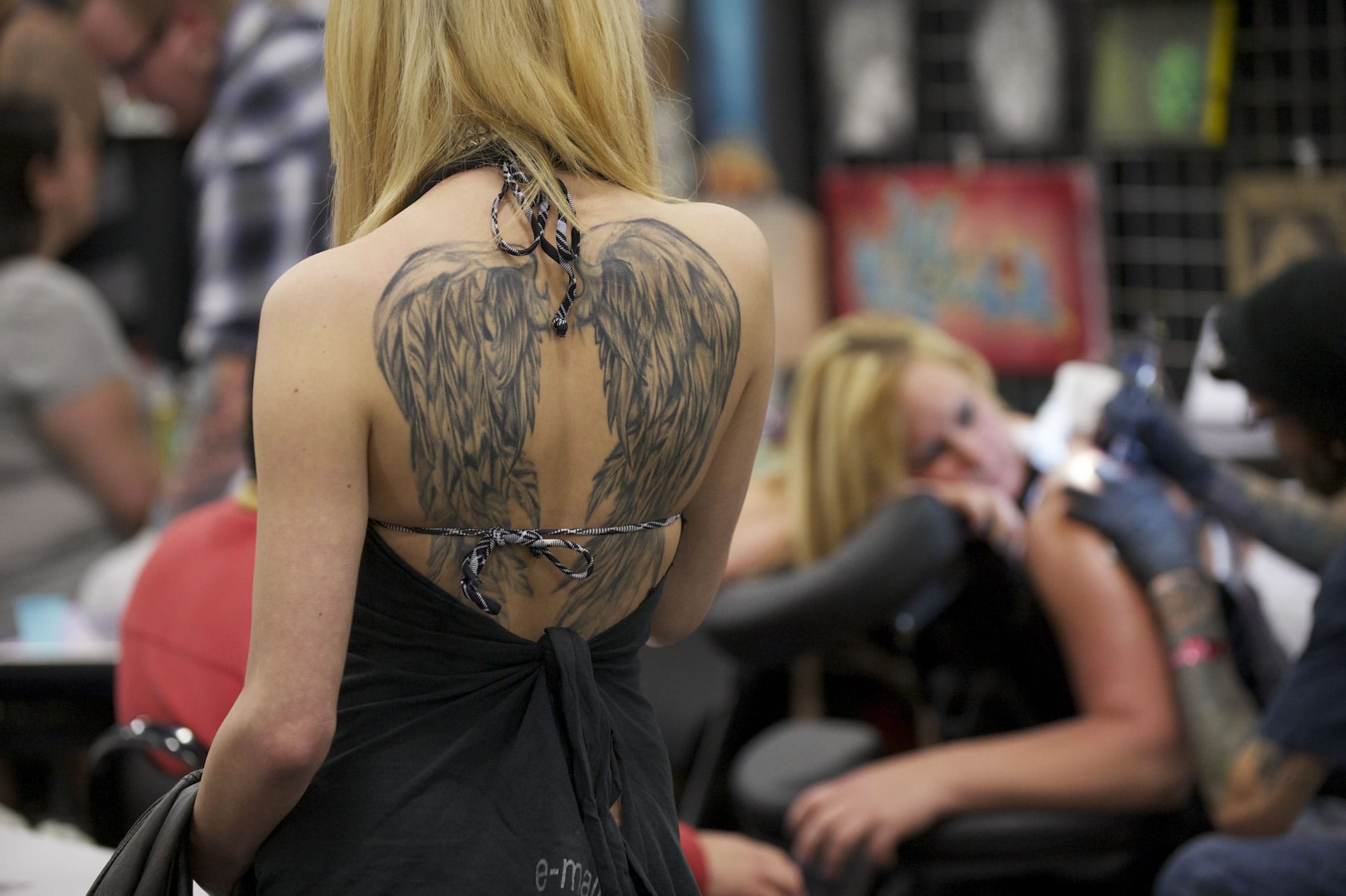 Tattoo artist Heather Mozo of Portland shows off a tattoo of wings on her back.