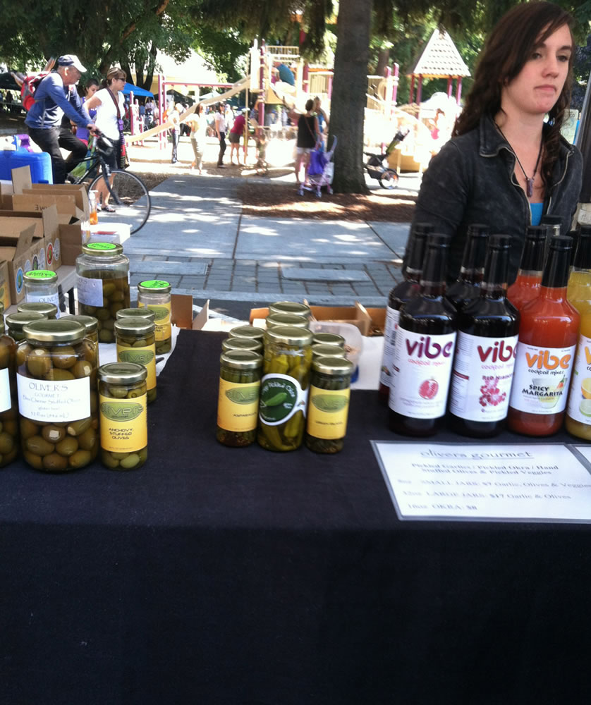 Hannah Berry sells a variety of pickled items at her father's stand, Oliver's, at the Vancouver Farmers Market.