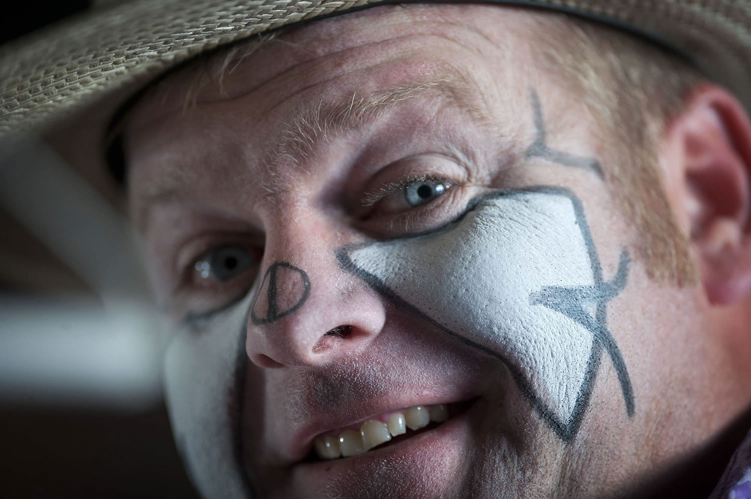 Rodeo clown Justin Rumford, 30, puts on his makeup.