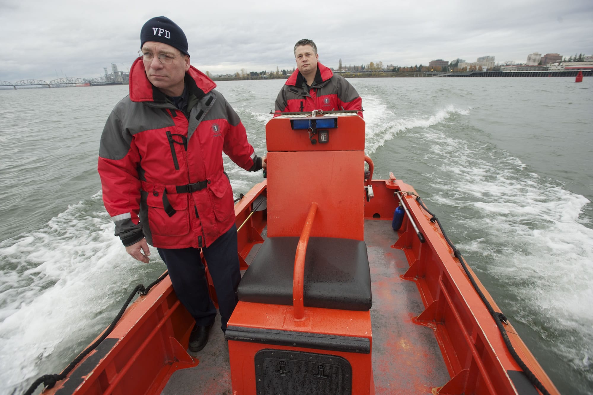 Vancouver Fire Department Captain Tom Coval, left, and firefighter Casey Holmes demonstrate the top speed of the department's boat on the Columbia River on Nov. 29. The boat maxes out at 20 miles per hour.