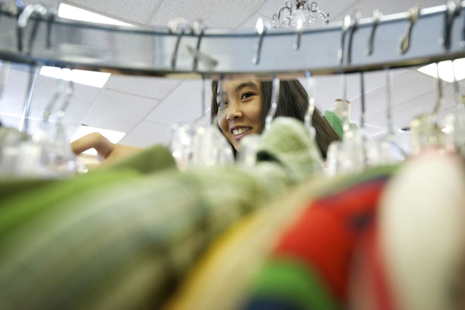 Skills Center student Julianne Cubacub, 17, sorts clothing at Deja Vu Consignment  on Tuesday.