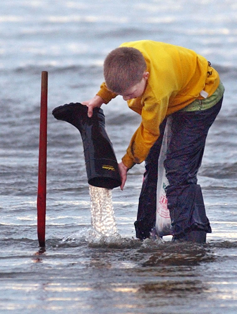 Water in a boot is one of the hazards of razor clam digging.
