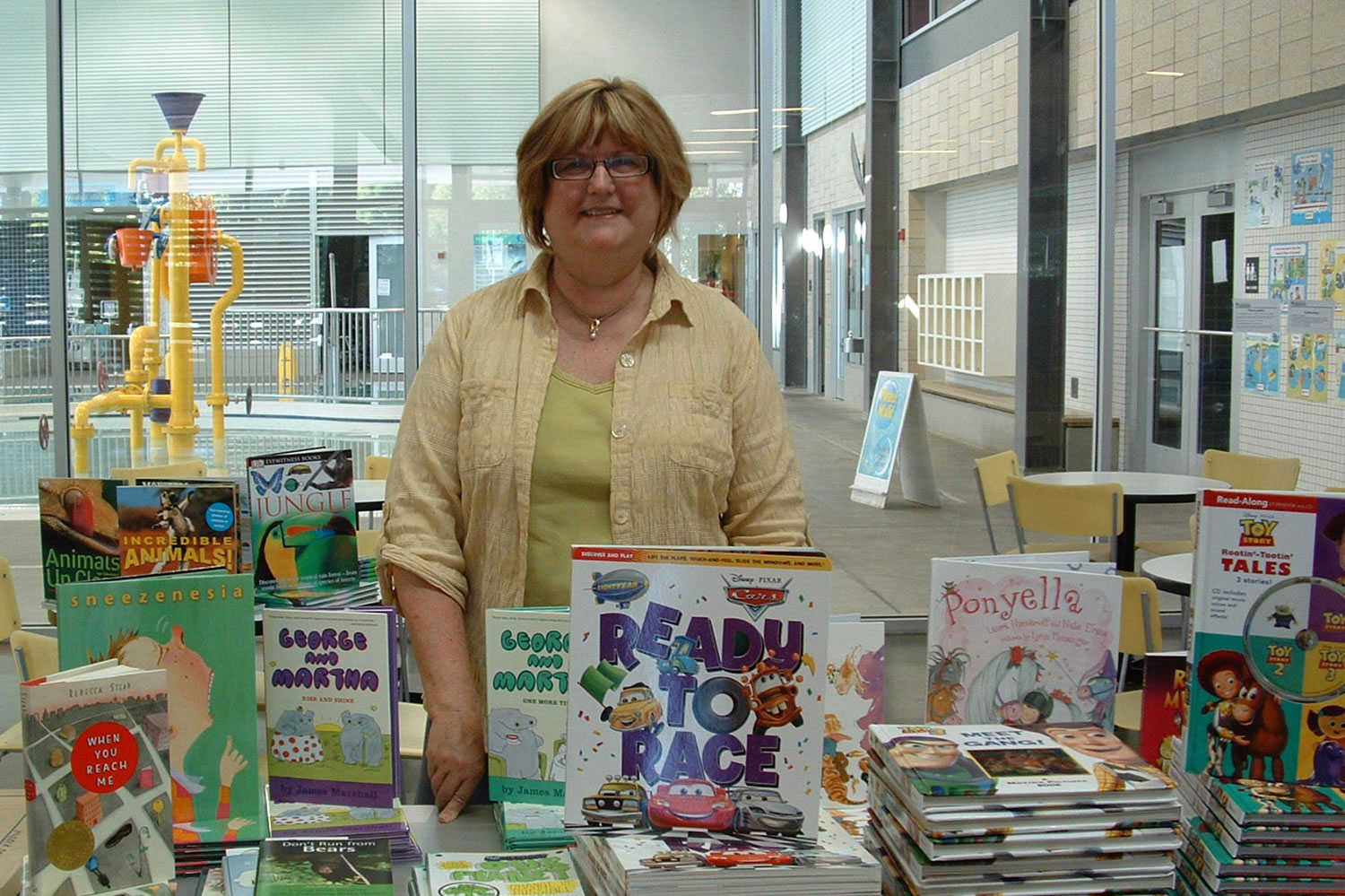 Fircrest: Altrusa International of Clark County President Tina Smith stands by more than 100 books that were given to local children Sept.