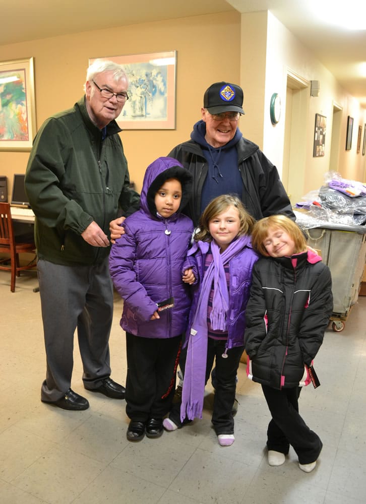 Esther Short: Harry Chaffee, left, and Jerry Andre of the Knights of Columbus passed along new coats to all the kids at Open House Ministries - like Ta'Nashia Jackson, 7, and sisters Madyson Oliver, 7, and Hailey Oliver, 5.