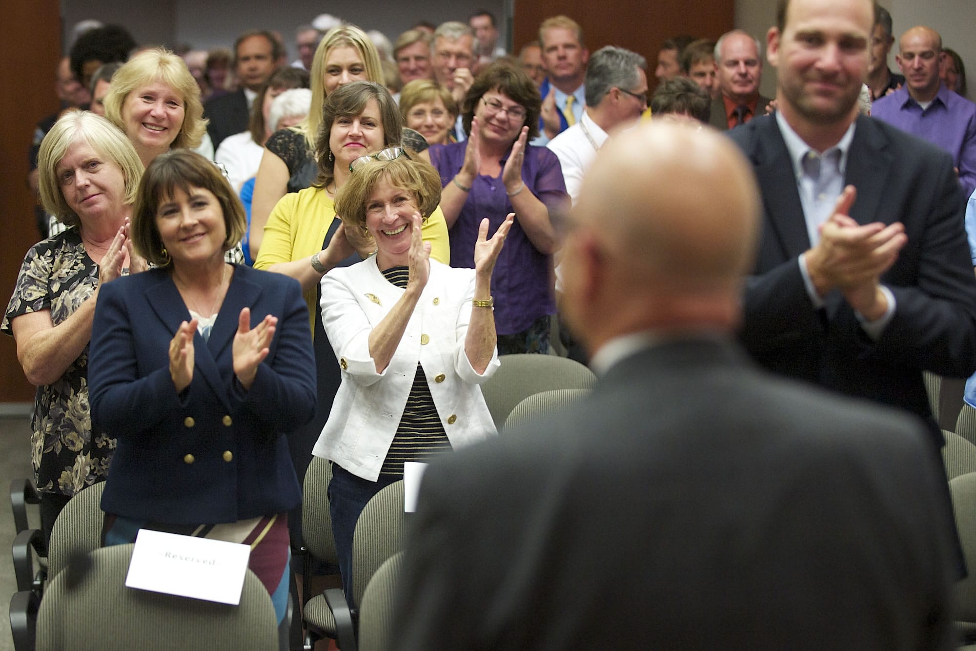Clark County Administrator Bill Barron looks upon a crowd of over 100 as they applaud him Thursday for his 14 years of service to the county. Former Clark County Commissioner Betty Sue Morris, center in white, said hiring Barron was among her best decisions as a commissioner.