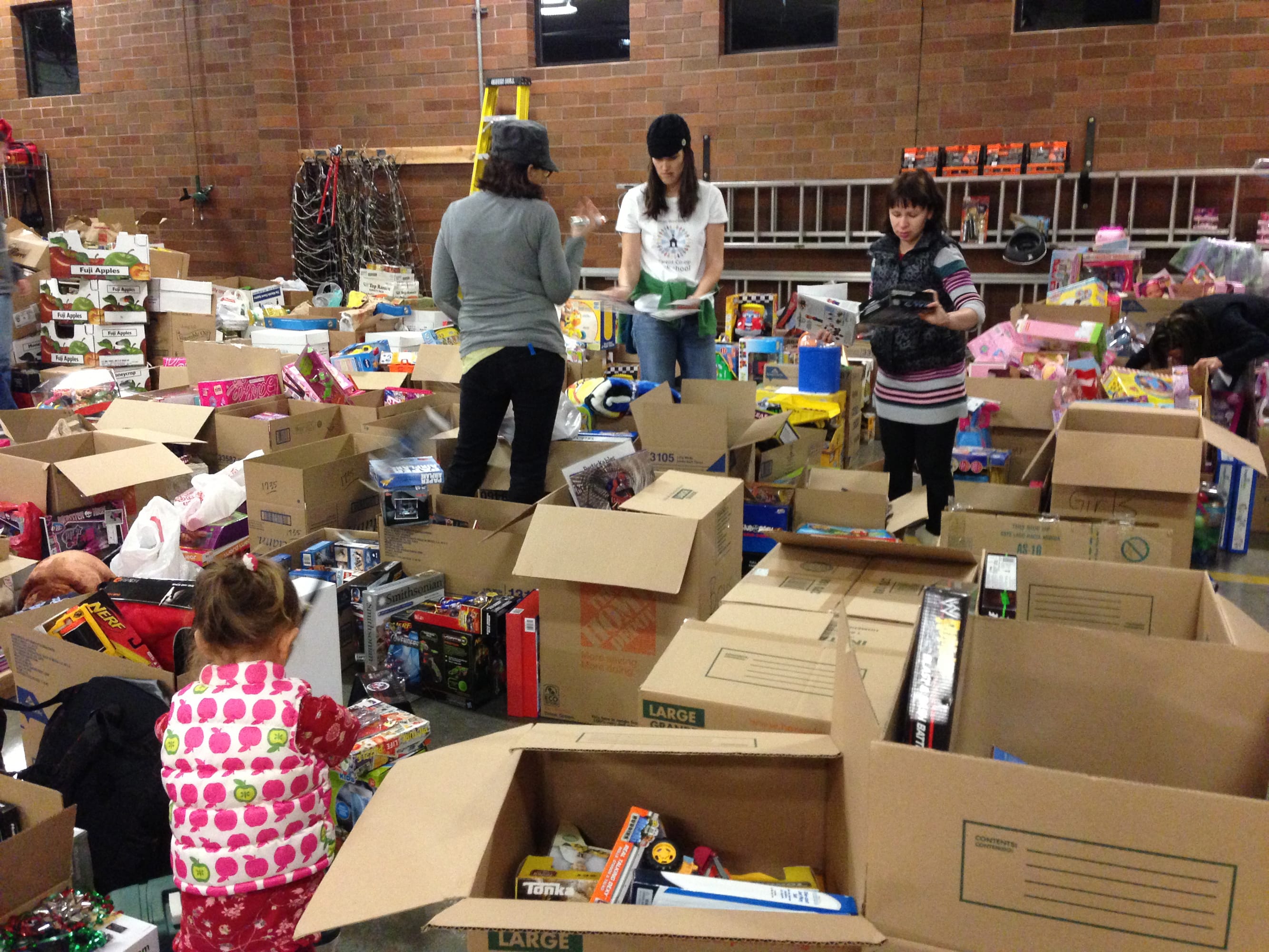Camas: Volunteers pack gifts on Dec. 19 to be delivered to families in need on Dec.