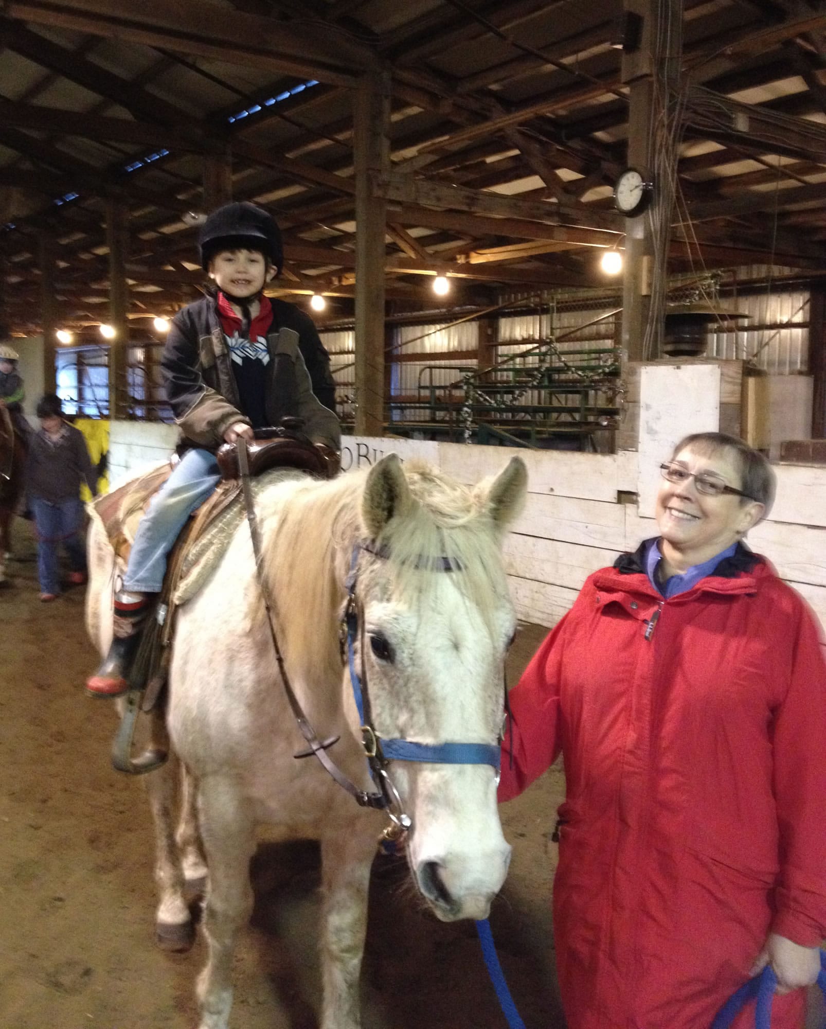 Brush Prairie: Volunteer Sara Jackson guides a boy as he rides a horse at Silver Buckle Ranch's Dec.