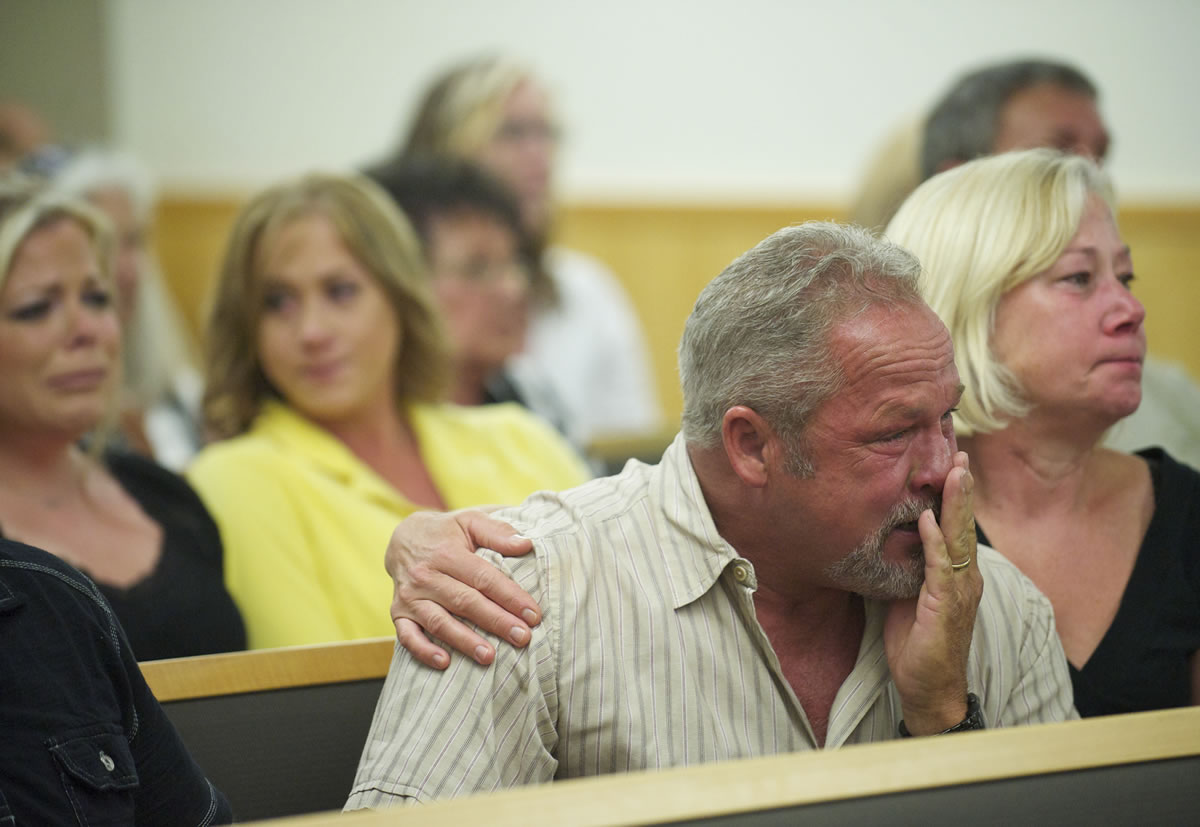 Tim Walswick, father of Eric Walswick, is comforted by family friend Carol Wiseman at the sentencing of Christopher D.