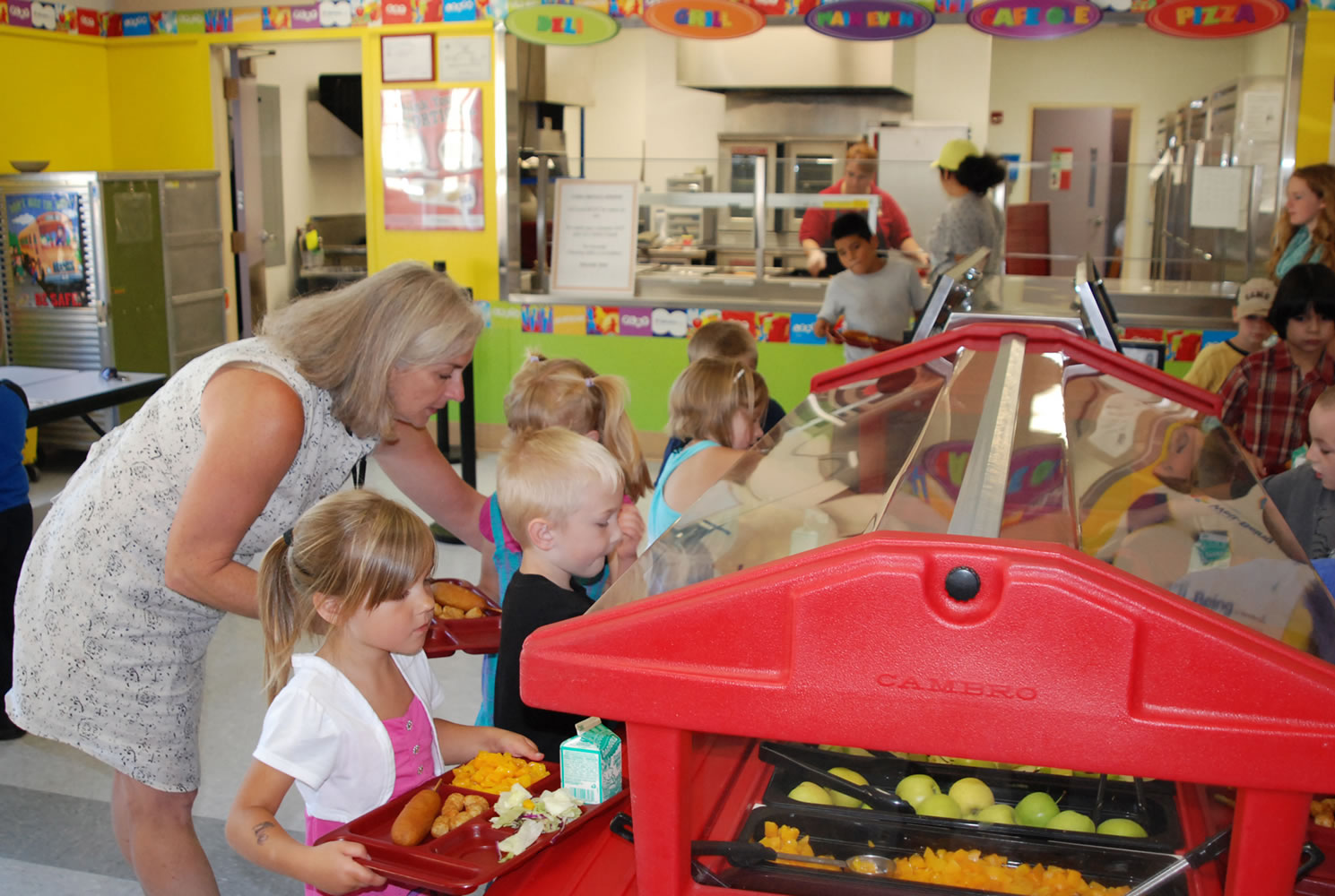 Washougal: Washougal School District Early Learning Technician Lisa Young guides children through the lunch line in July at Hathaway Elementary School.
