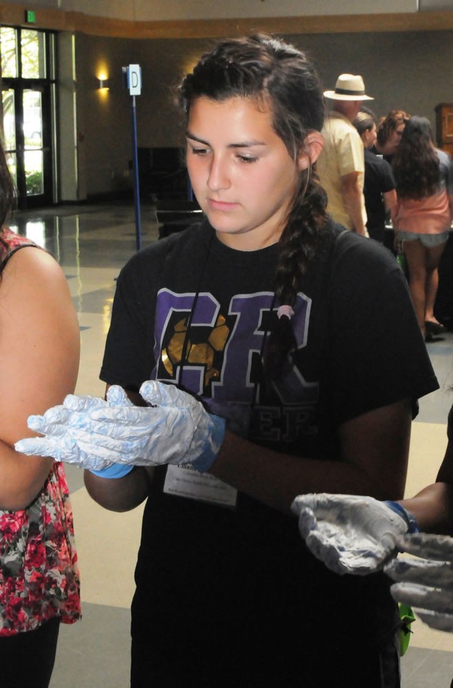 Lincoln: Lili Delgadillo learns proper hand-washing and equipment-sanitizing techniques during Washington Business Week's health care camp.