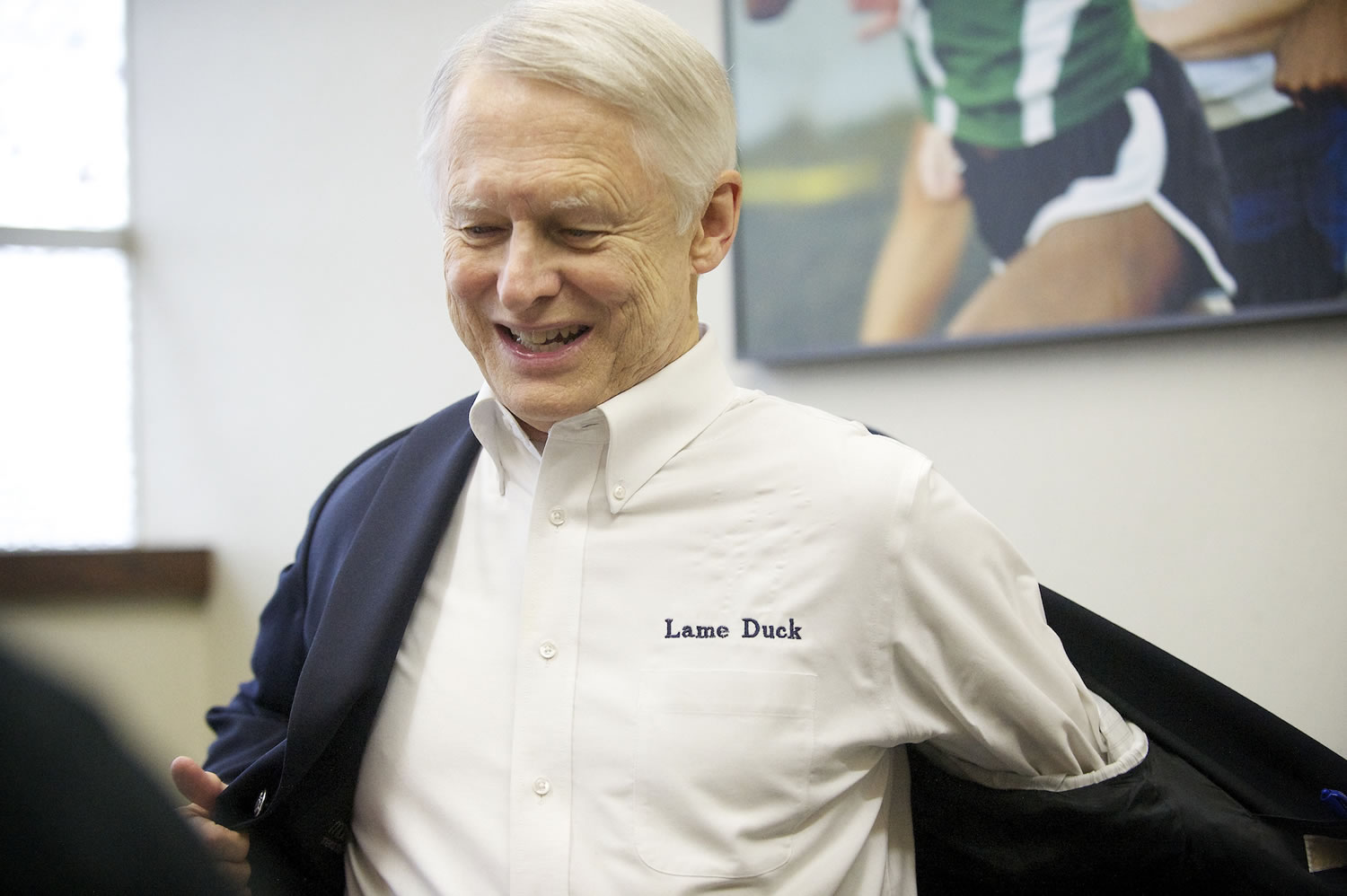 During his Vancouver visit Wednesday, Secretary of State Sam Reed sported a white button up shirt with the words &quot;Lame Duck&quot; embroidered above the chest pocket, a humorous reference to the fact that he did not seek re-election.