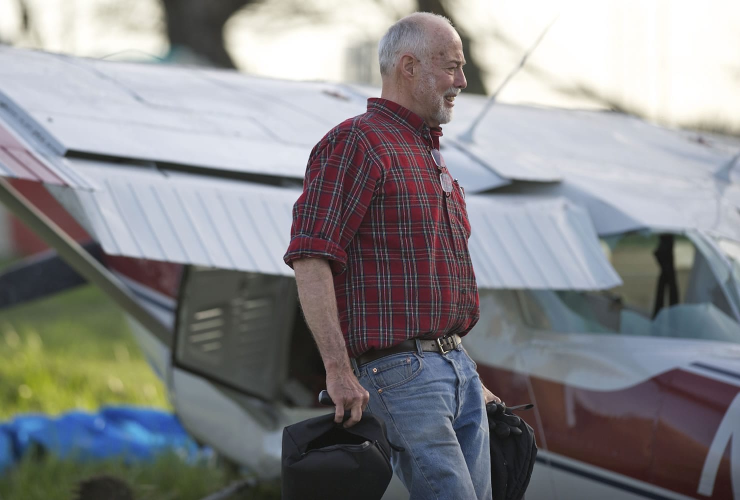 Pilot Phil Allen of Portland grabs belongings out of his 1964 Cessna 150 after it crashed Sunday.