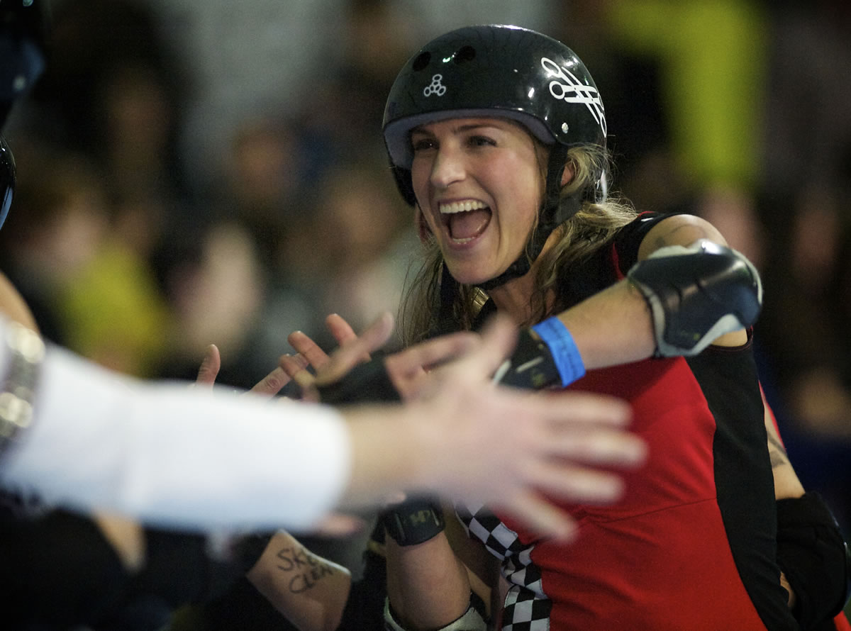 Jessica &quot;Chestnutz&quot; Chestnut slaps hands with skaters after her team, the Break Neck Betties, loses a close match against the Guns N Rollers at the Hangar at Oaks Park on March 23.