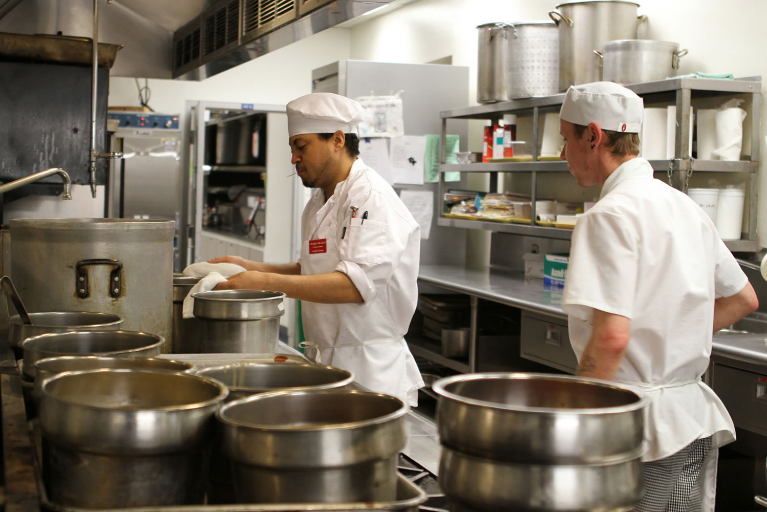 Clark College students Louis Cayson, left,  and Timothy Henley prepare food at the Clark College cafeteria.  The college's culinary arts program is undergoing a redesign that will change the curriculum and possibly upgrade dining and kitchen facilities.
