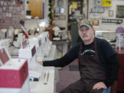 Gary Rael, general manager of House of Sewing Machines &amp; Vacuums, works at his shop in Hazel Dell last week.