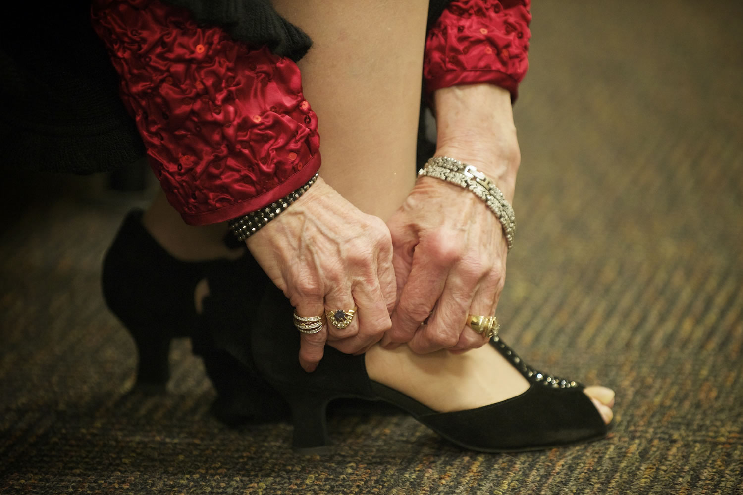 Barbara Scherr of Vancouver puts her dancing shoes on before the Swinging in the New Year&#039;s Eve Dance in 2013 in Vancouver.