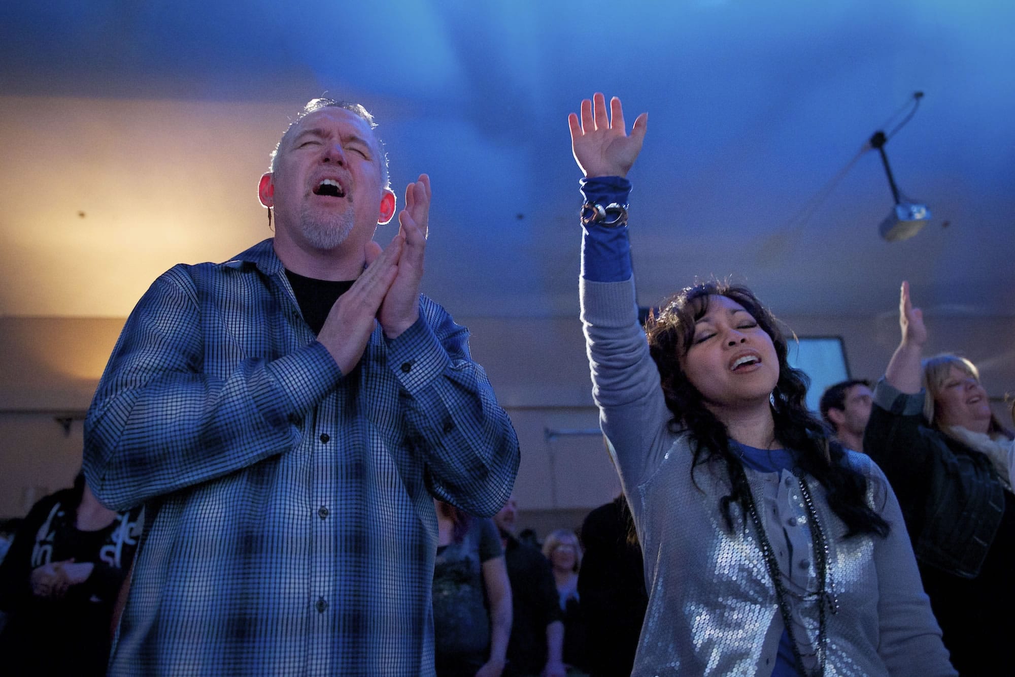 Pastor Bill Smith, left, and his wife, Vicky Smith, with The XChange Church, worship at the Faith Center Church at the first joint service of the churches.