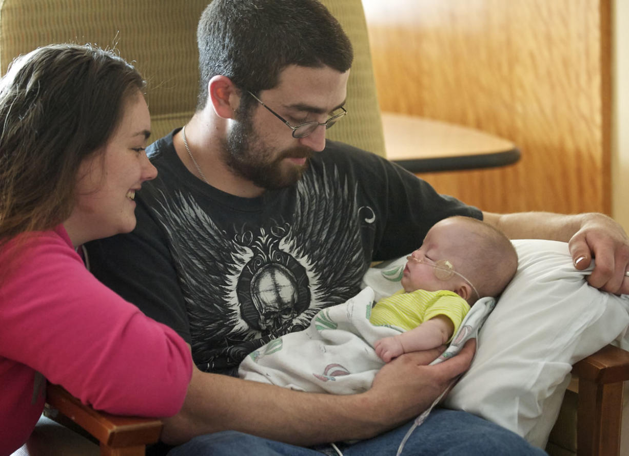 Tiffany Burril and Mitchall Gulliksen visit their daughter, Harley, in the neonatal intensive care unit at Legacy Salmon Creek Medical Center Thursday. Harley was born prematurely at 27 weeks gestation.
