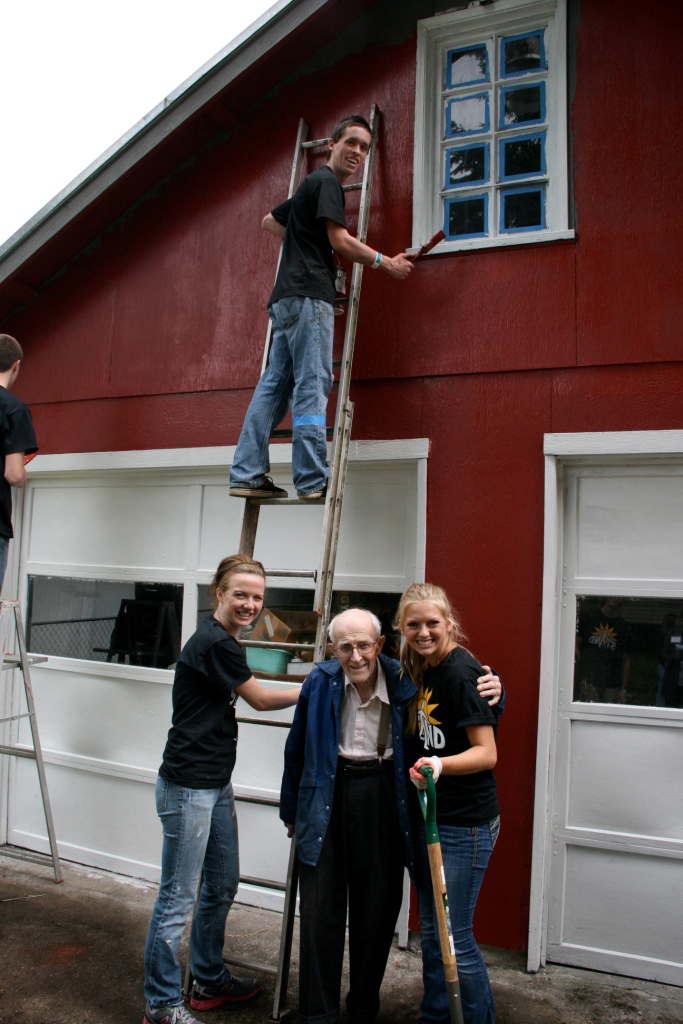 Salmon Creek: Courtney Wood, left, and Jordon Jackson, right, both of Vancouver, helped paint Walter Remme's garage during a massive volunteer effort by Mormon teens in Clark County.