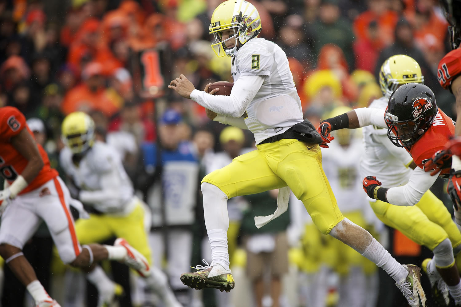 Oregon's Marcus Mariota picks up a first down Oregon State on Saturday at Reser Stadium in Corvallis.