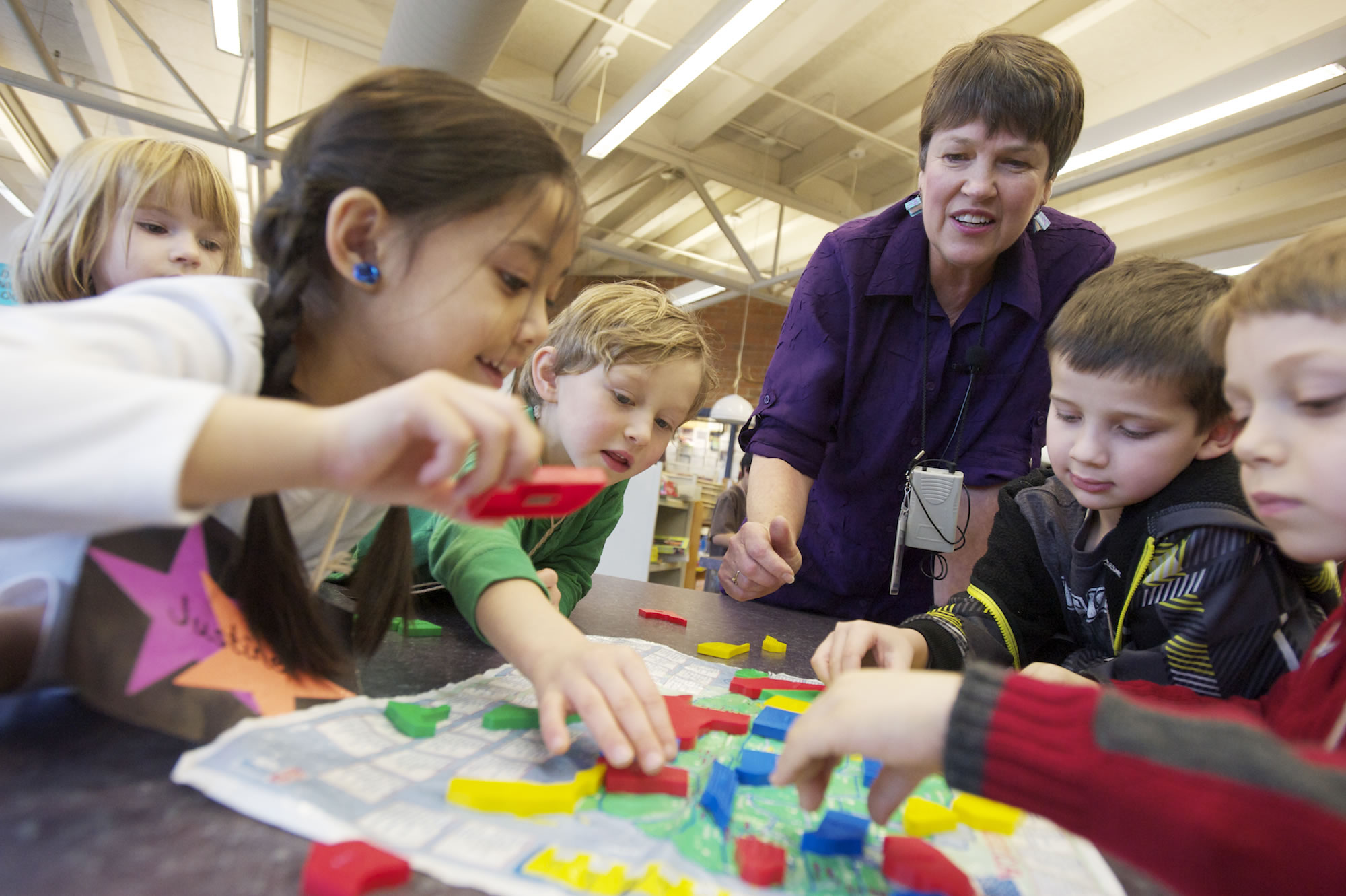 Teacher-librarian Kay Ellison helps Marshall Elementary School kindergartners, from left, Jadyn Christensen, Justine Franco, Brian Deming, Will Garrett and Andrew Banceu with a puzzle.