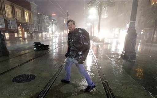A man crosses Canal Street in the wind and rain from Hurricane Isaac today in New Orleans.