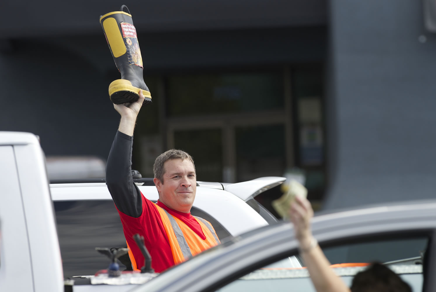 Vancouver Fire Department's Tom Cook collects a donation from a motorist on Northeast 78th Street near Interstate 5 in Hazel Dell on Thursday as part of &quot;Fill the Boot,&quot; which raises money for the Muscular Dystrophy Association.