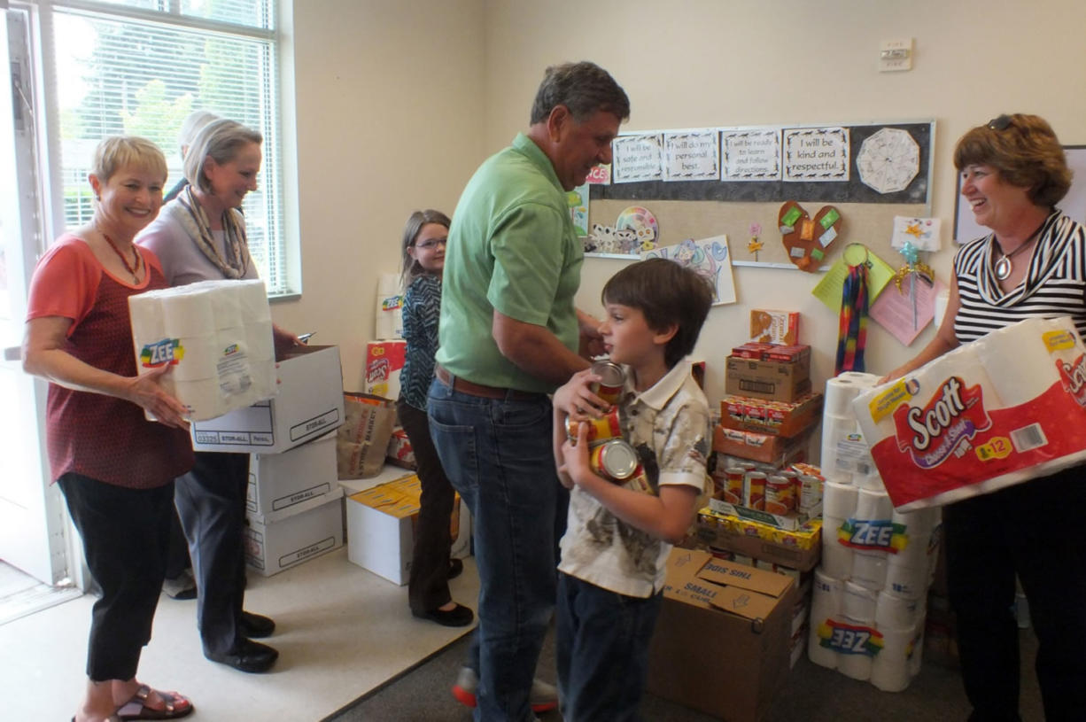 Fruit Valley: Local Windermere employees and their children deliver food to Fruit Valley Elementary School on June 28.