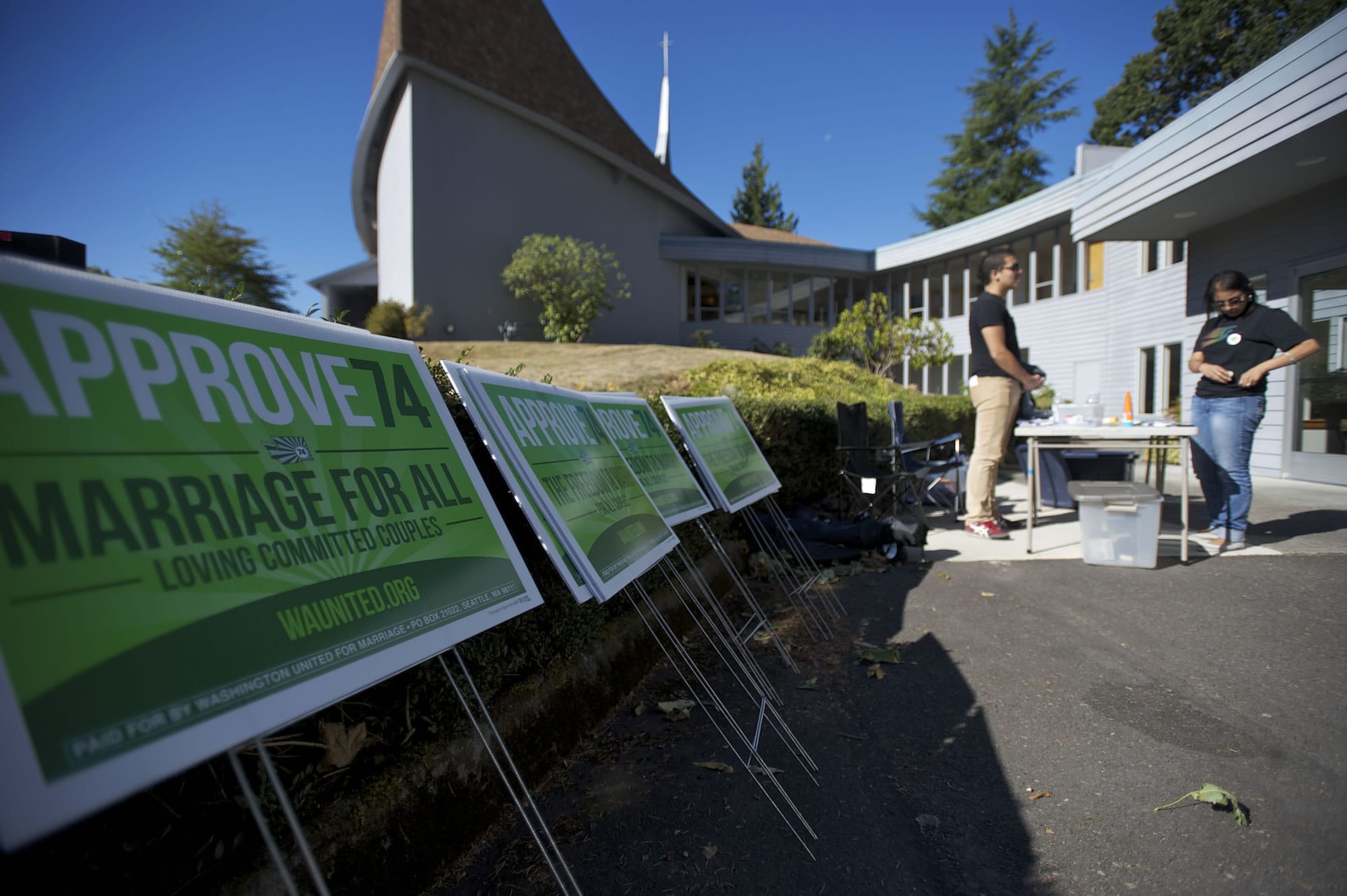 Same-sex marriage advocates Justin Pabalate, 31, and Jessica Nguyen-Ventura, 26, both of Portland, gather at the First Congregational Church in Hazel Dell before volunteers canvassed neighborhoods on Oct.