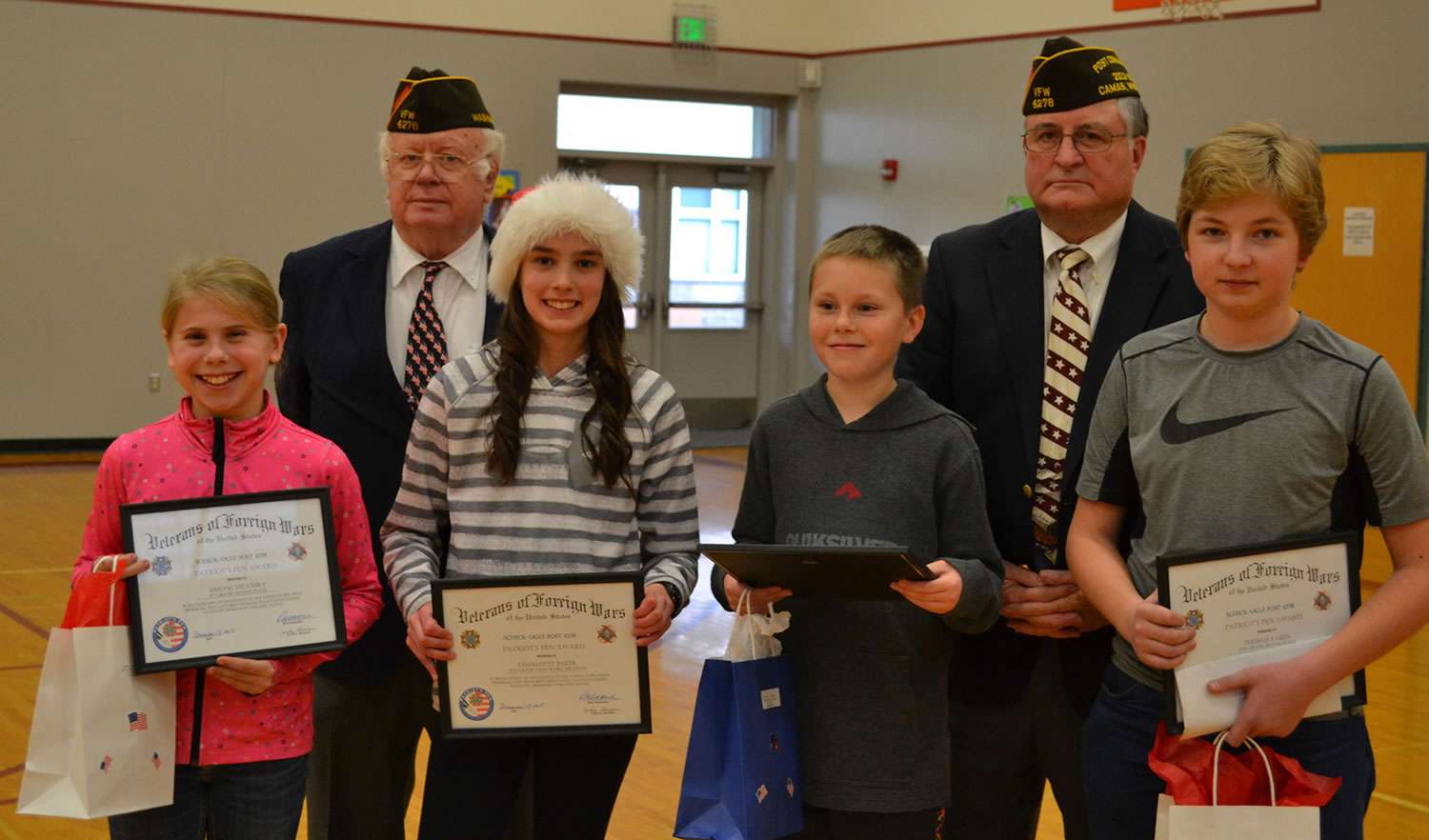 Washougal: Veterans of Foreign Wars members Ray Loney, back row from left, and Robert Hitchcock handing out awards to winners of the organization&#039;s annual essay contest to Canyon Creek Middle School students, from left: Simone Velanskey, Charlotte Baker, Bryce Holmes and Thomas Hein.
