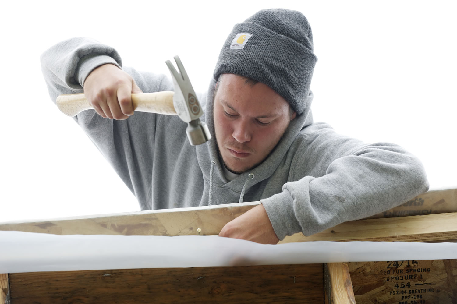 Thaddaeus Fronk, a student at the Clark County Skills Center, works on a Habitat for Humanity house built in partnership with Evergreen Public Schools.