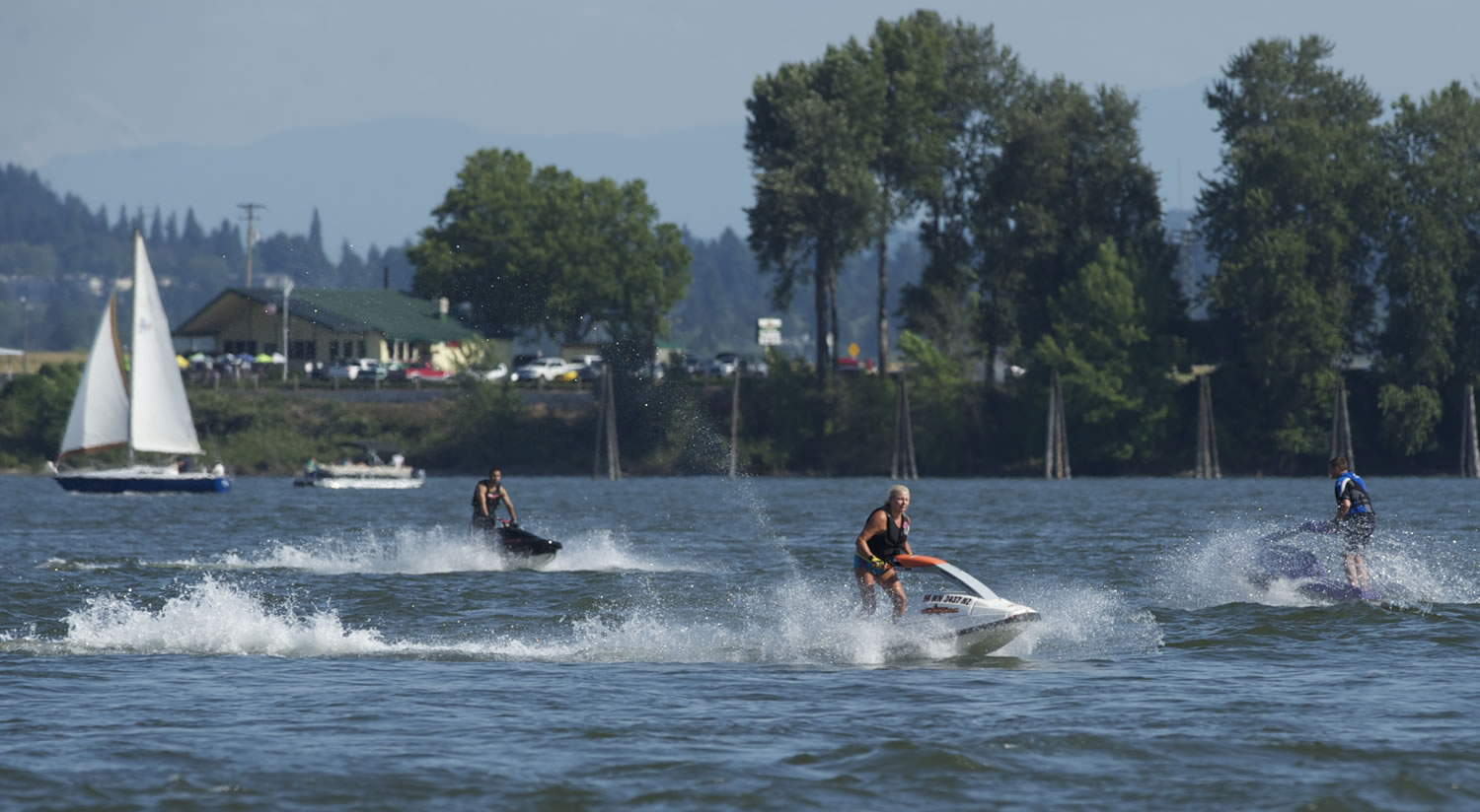 Steven Lane/The Columbian
Personal watercraft riders keep cool Friday by playing on the Columbia River.