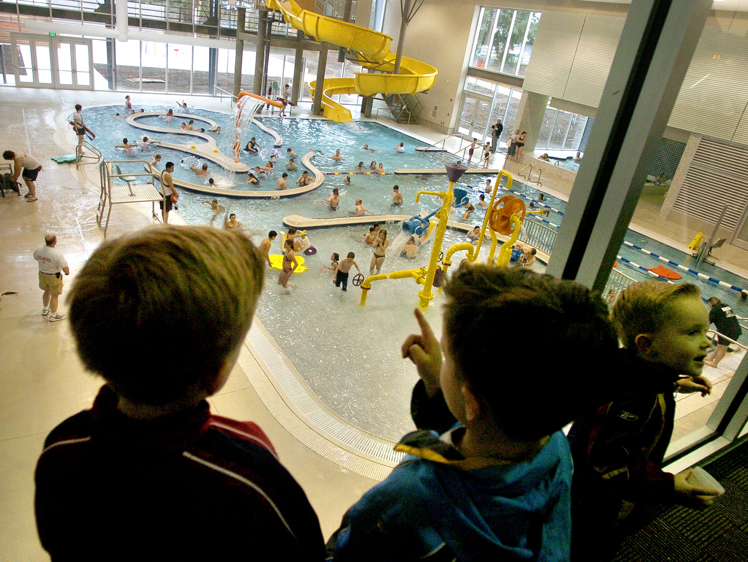Dillon Gohl of Camas, 7, from left, and his brothers Tanner Gohl, 6, and Austin Gohl, 4, look down at the  Firstenburg Community Center pool on Feb. 26, 2006, the day of the center's grand opening dedication.