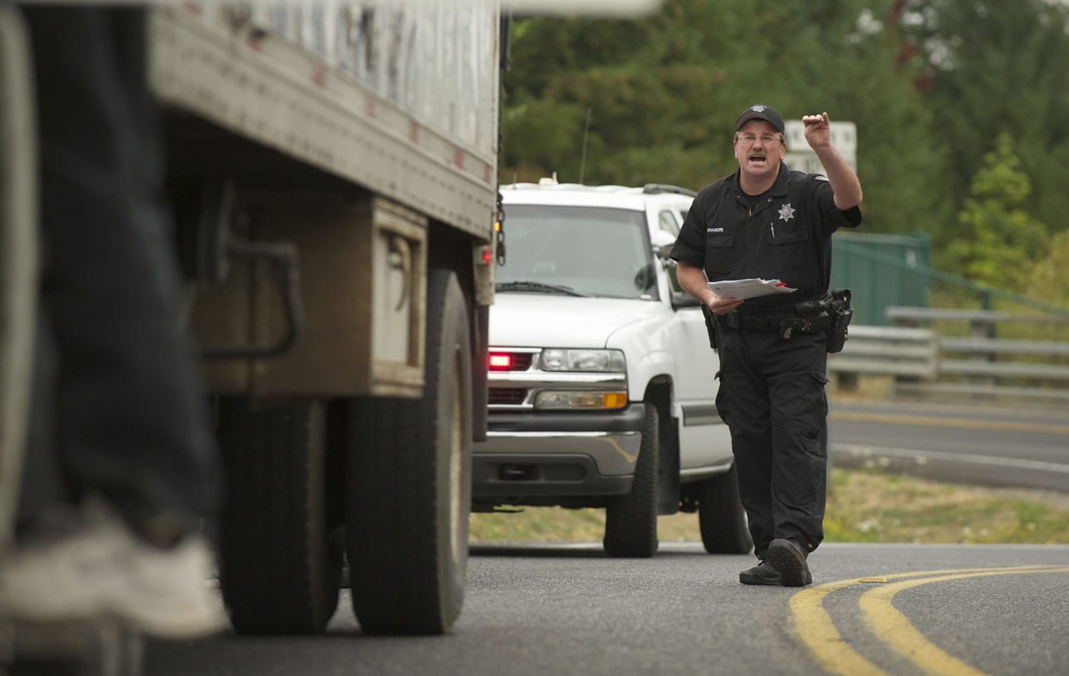 Clark County Sheriff's Deputy James Naramore stops a truck driver at Northeast 10th Avenue and Carty Road on Sept.