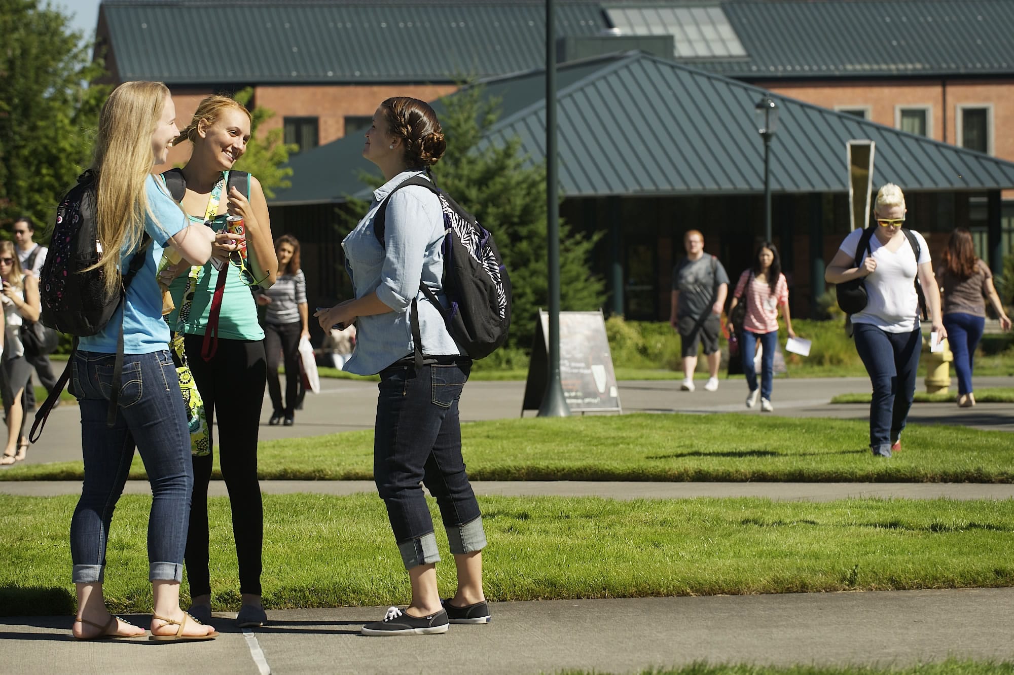 Students, from left, Emily Vis, 20, Miranda Bierscheid, 18, and Kaitlyn McClain, 20, visit during the first day of classes at Washington State University Vancouver on Monday.