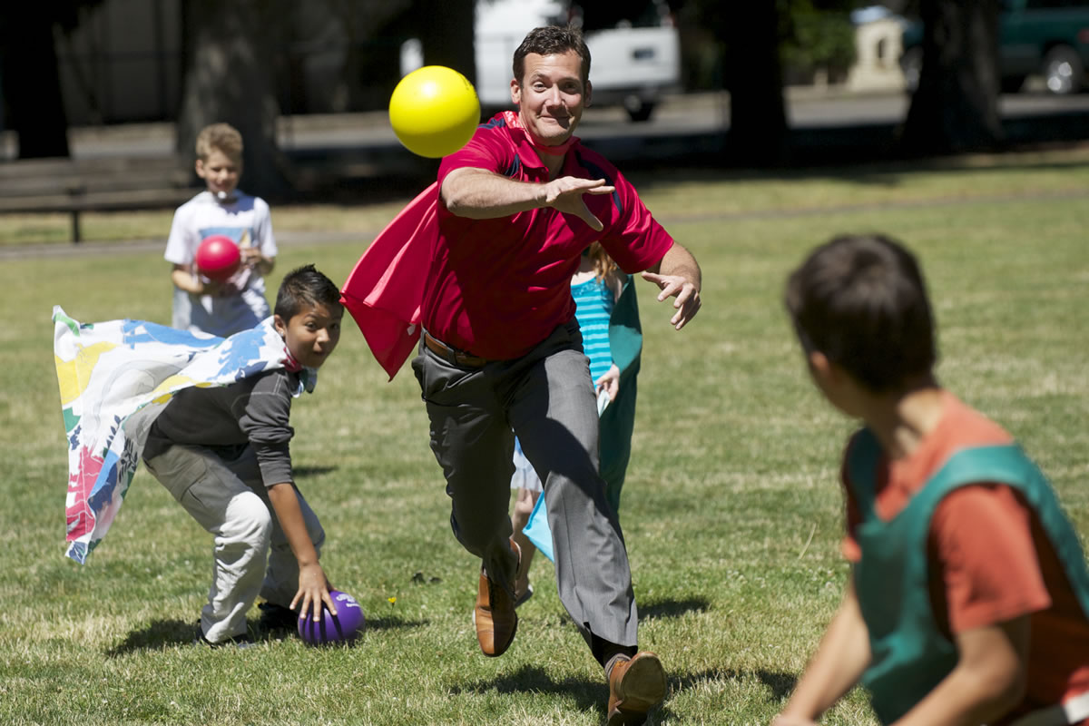 Vancouver Mayor Tim Leavitt plays a game of dodgeball with kids taking part in a day camp at Evergreen Park, which has benefited from donations aimed at keeping the camp running.