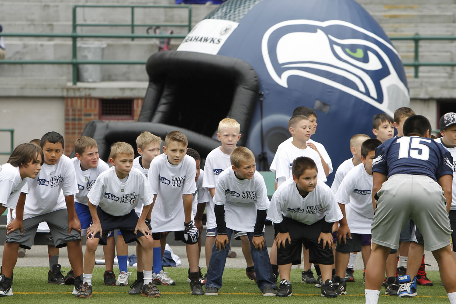Kids get instructions during the Seahawks junior football training camp at Kiggins Bowl on Sunday.