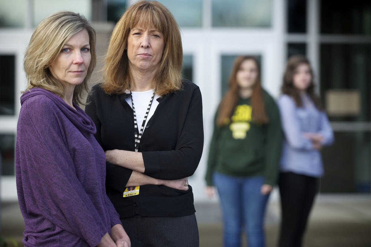 From left, Krista Roadifer, school counselor; Kelly Johnson, a Battle Ground school district psychologist; and eighth-grade students Sarah Miller and Madison Schumacher stand outside Chief Umtuch Middle School.
