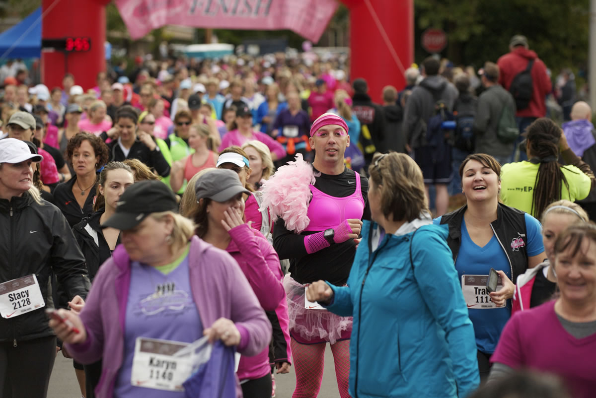 Participants leave the starting line of the 2012 Girlfriends Half Marathon on Sunday. Profits from the event will go to Susan G.