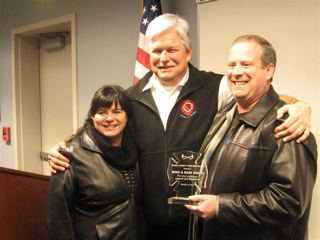 Hockinson: Clark County Fire District 3 Chief Steve Wrightson presents Mike and Kari Smith of Hockinson with the Sylvia Kiive Good Neighbor Award on Dec. 14.