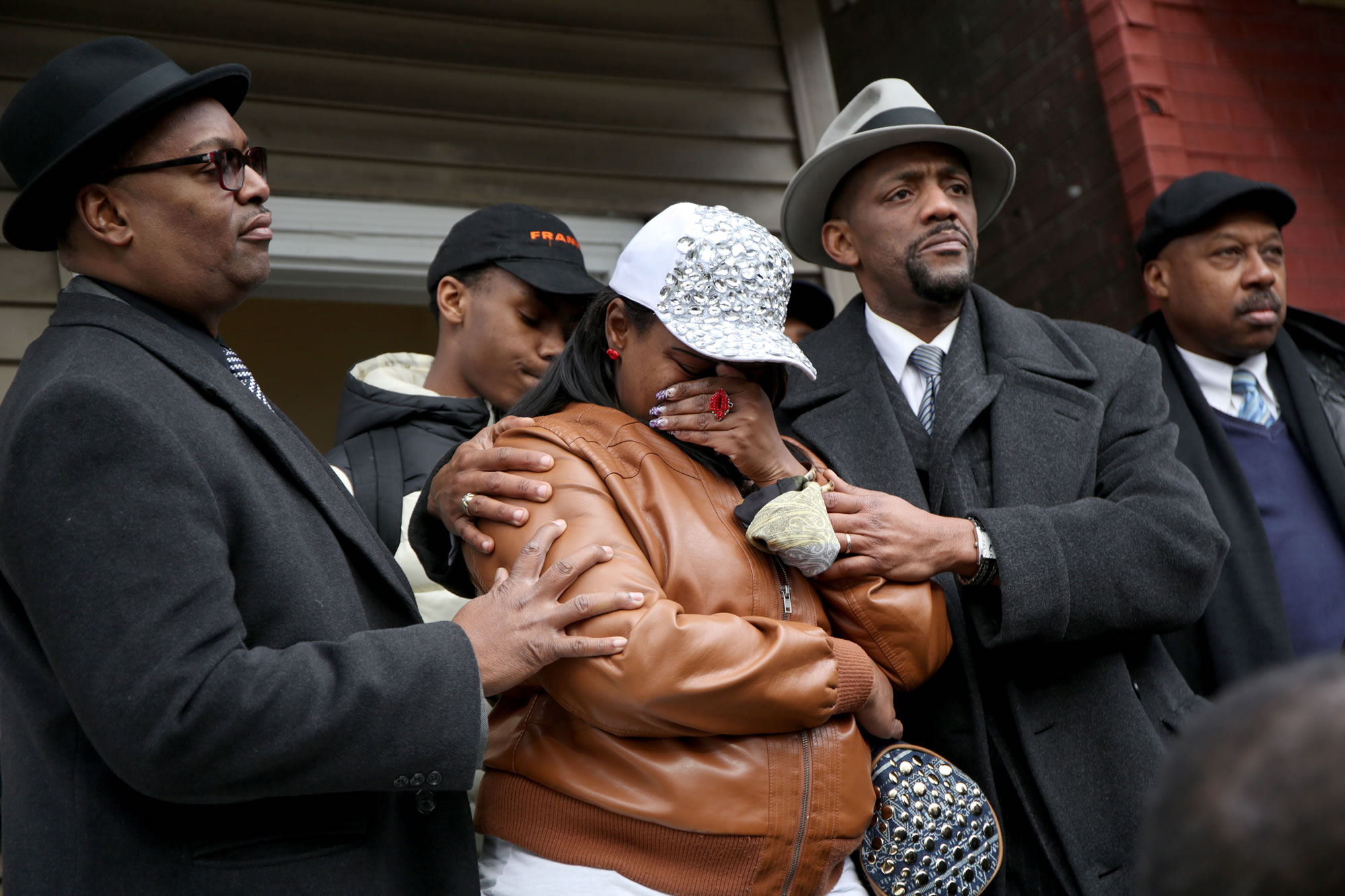 LaTarsha Jones, center, the daughter of Bettie Jones, is comforted by family and friends during a press conference Sunday in front of the house where Bettie Jones was killed Saturday in the West Garfield Park neighborhood of Chicago.