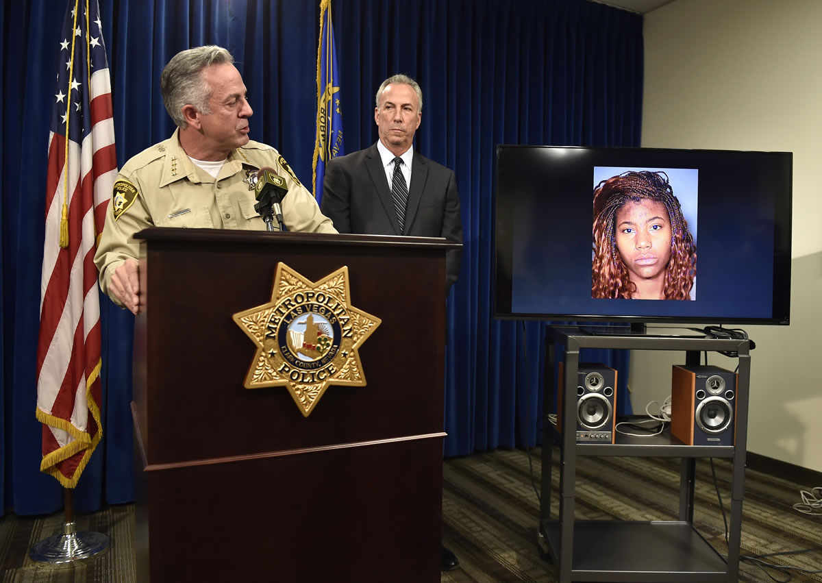 Clark County Sheriff Joe Lombardo, left, and Clark County District Attorney Steve Wolfson attend at a news conference Monday in Las Vegas. The two officials spoke about the car driven by suspect Lakeisha N. Holloway, pictured on monitor, of Oregon, who police said smashed into crowds of pedestrians on the Las Vegas Strip on Sunday night, killing one person and injuring dozens.